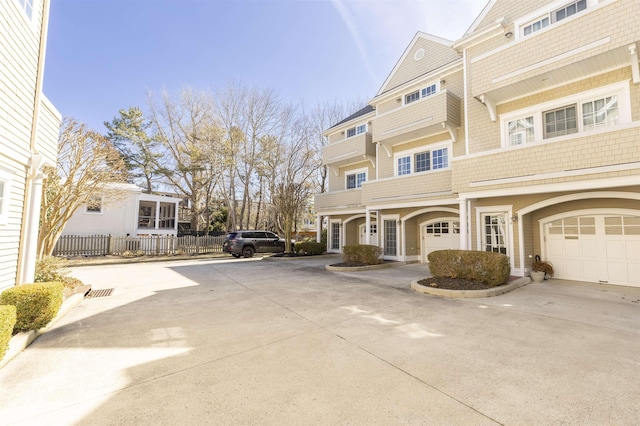 view of front of house featuring fence and a garage