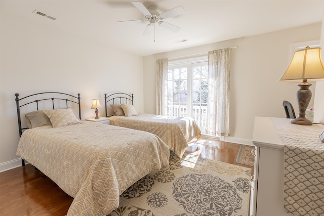 bedroom featuring wood finished floors, visible vents, and baseboards