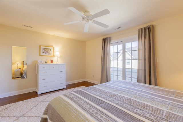 bedroom featuring visible vents, ceiling fan, baseboards, and dark wood-style flooring