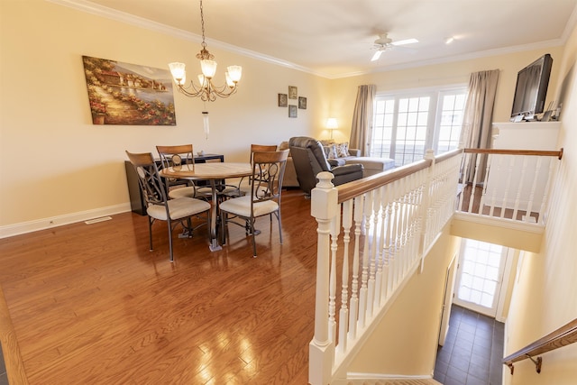 dining area with crown molding and wood finished floors