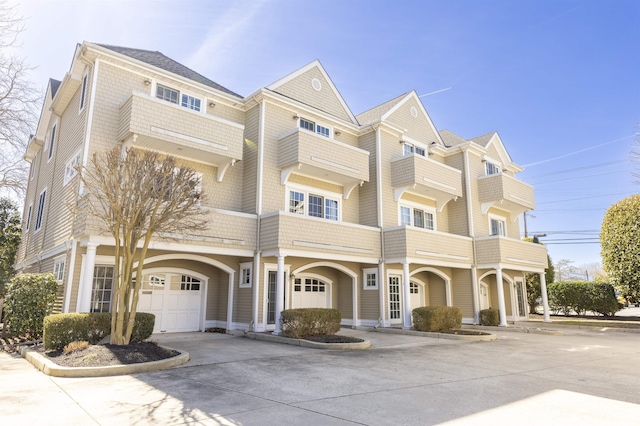 shingle-style home with concrete driveway