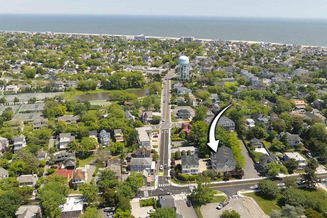 drone / aerial view featuring a residential view and a water view