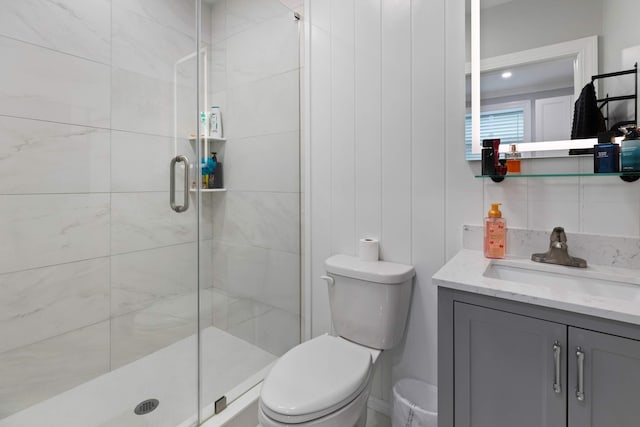 bathroom with vanity, toilet, and a stall shower