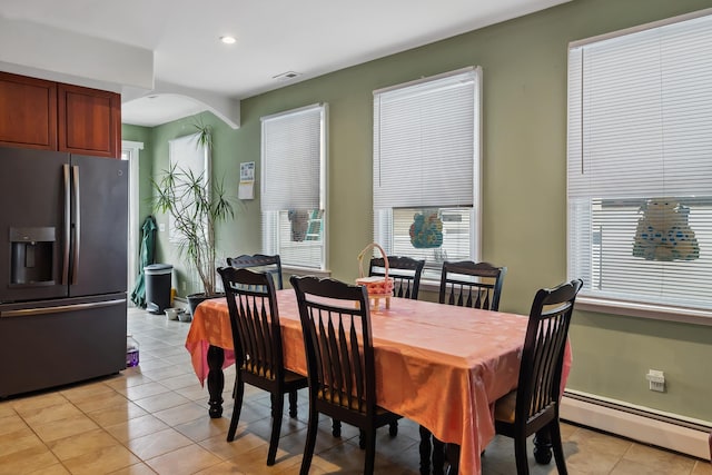 dining room featuring recessed lighting, visible vents, light tile patterned floors, a baseboard heating unit, and arched walkways