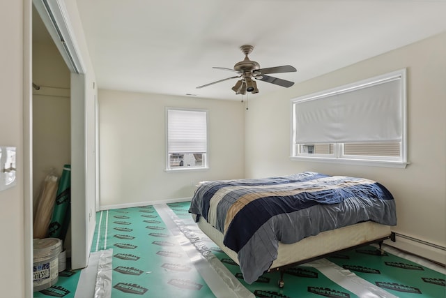 bedroom with baseboards, ceiling fan, and baseboard heating