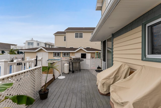 wooden deck with a grill