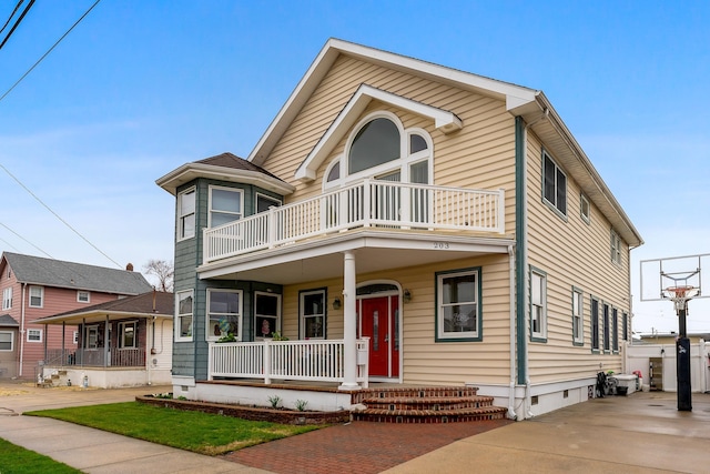 view of front of home featuring a porch, crawl space, and a balcony