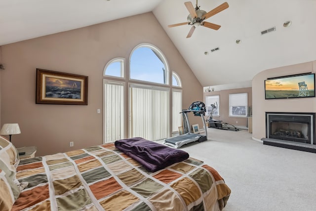 bedroom featuring high vaulted ceiling, a ceiling fan, carpet, a fireplace, and visible vents