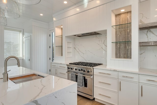 101 Harvard Ave, Cape May Point, NJ 08212 - kitchen featuring exhaust hood, white cabinets, high end stainless steel range, and a sink