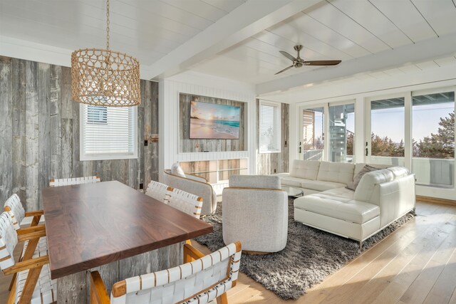 101 Harvard Ave, Cape May Point, NJ 08212 - living room with wood finished floors, beam ceiling, radiator heating unit, ceiling fan, and wood walls