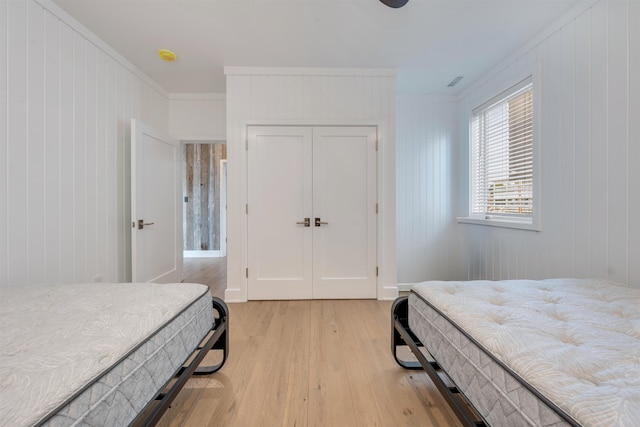 101 Harvard Ave, Cape May Point, NJ 08212 - bedroom with crown molding, light wood-style flooring, and a closet