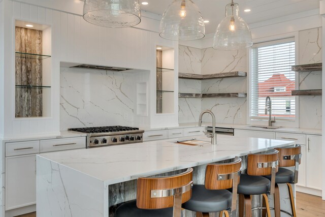 101 Harvard Ave, Cape May Point, NJ 08212 - kitchen featuring a kitchen island with sink, a sink, stainless steel gas stovetop, white cabinets, and open shelves