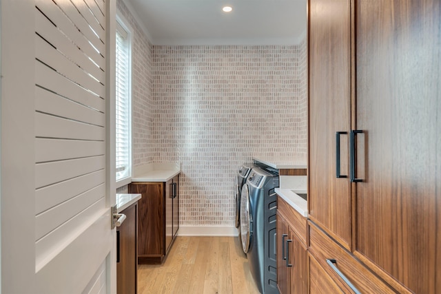 101 Harvard Ave, Cape May Point, NJ 08212 - laundry room with light wood finished floors, plenty of natural light, cabinet space, and washing machine and clothes dryer