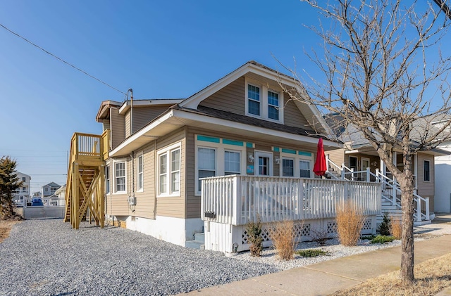 bungalow-style home featuring covered porch and stairs