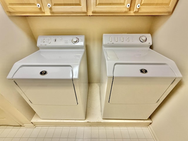 washroom with cabinet space and independent washer and dryer