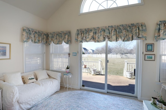 bedroom with access to exterior and high vaulted ceiling