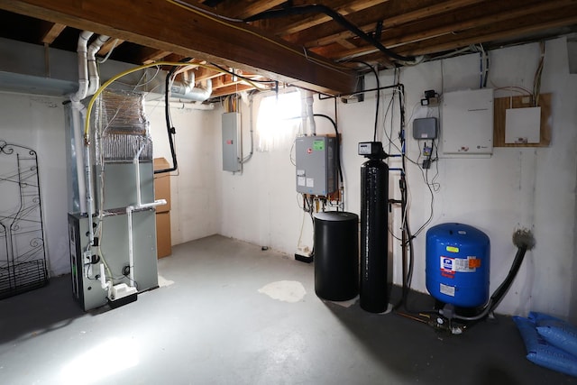 basement featuring heating unit and electric panel