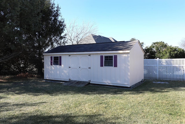 view of outbuilding with a yard