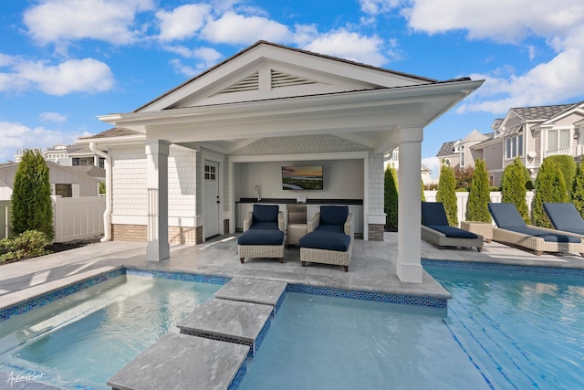 outdoor pool featuring outdoor dry bar, a sink, a patio, fence, and a gazebo