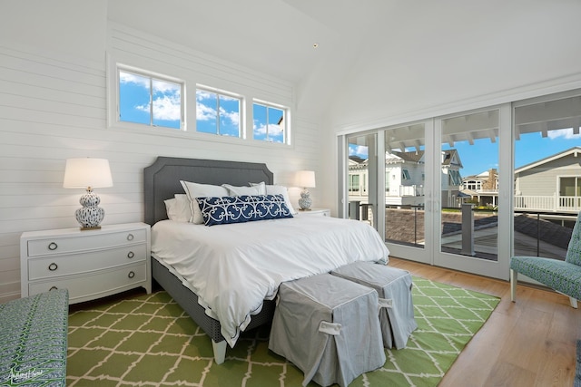 bedroom featuring wood finished floors and access to exterior