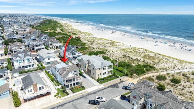 bird's eye view featuring a view of the beach and a water view