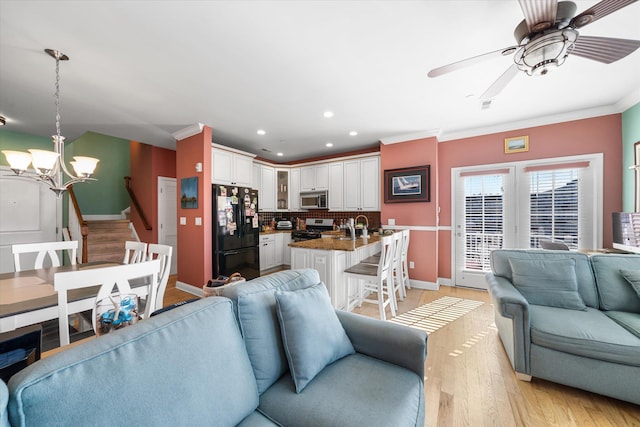 3814 Landis Ave Unit 1, Sea Isle City, NJ 08243 - living room with ornamental molding, ceiling fan with notable chandelier, and light wood-type flooring