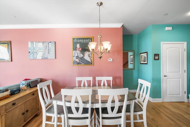 3814 Landis Ave Unit 1, Sea Isle City, NJ 08243 - dining area featuring crown molding, a chandelier, and light hardwood / wood-style floors