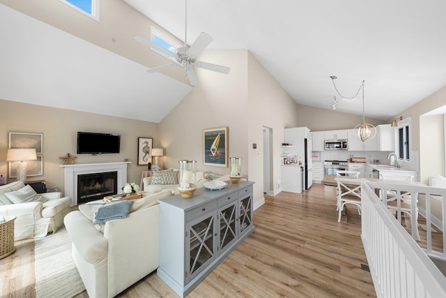 255 117th St Unit 2, Stone Harbor, NJ 08247 - living room featuring a fireplace, high vaulted ceiling, a ceiling fan, and light wood-style floors