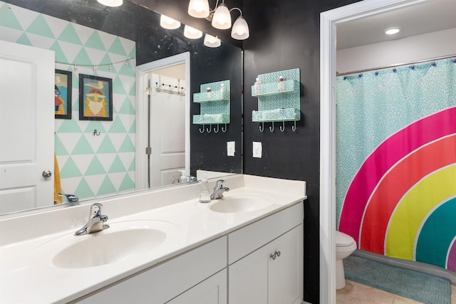 bathroom featuring tile patterned flooring, vanity, and toilet