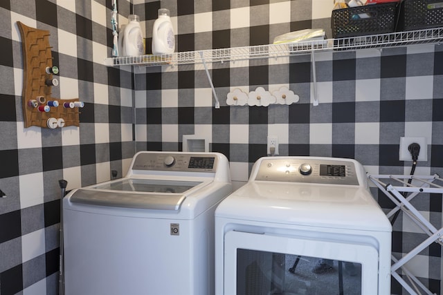 washroom with washing machine and clothes dryer