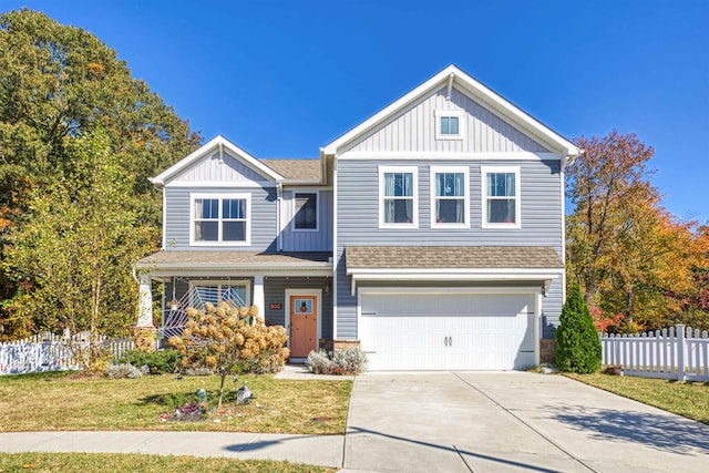 view of front of property with a garage and a front lawn