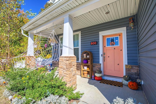 view of exterior entry featuring a porch