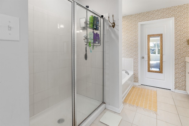 bathroom featuring tile patterned flooring and shower with separate bathtub