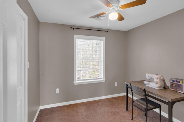 office space featuring visible vents, a ceiling fan, baseboards, and carpet floors