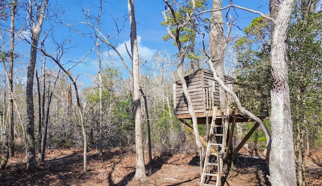 exterior space with a wooded view