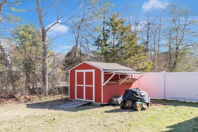 view of shed featuring fence