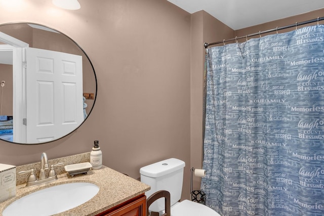 bathroom featuring vanity, curtained shower, and toilet