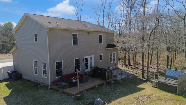 back of house featuring a deck, a shingled roof, and a yard