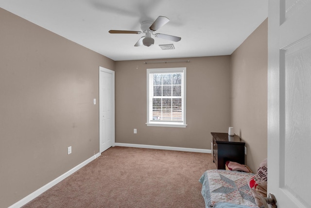 unfurnished bedroom with visible vents, baseboards, a ceiling fan, and carpet flooring