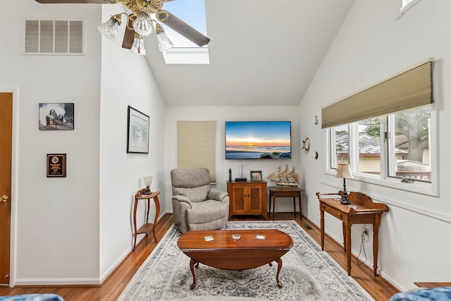 117 W Drumbed Rd, Villas, NJ 08251 - living room featuring ceiling fan, light wood-style floors, high vaulted ceiling, and a skylight