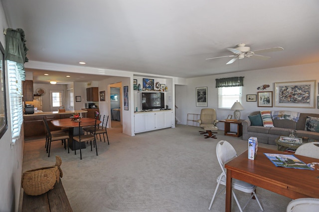 carpeted living room featuring ceiling fan