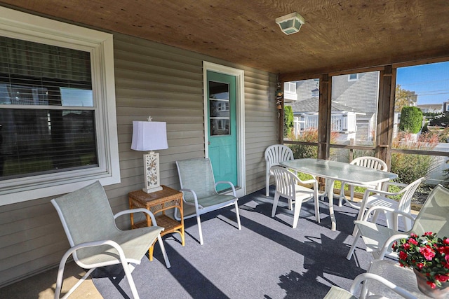 sunroom featuring wood ceiling