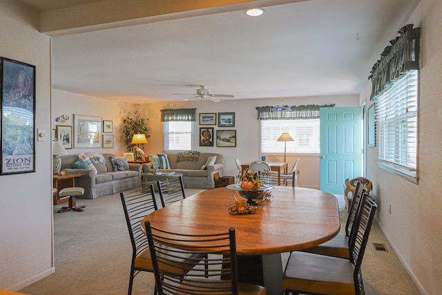 dining area with light carpet and ceiling fan