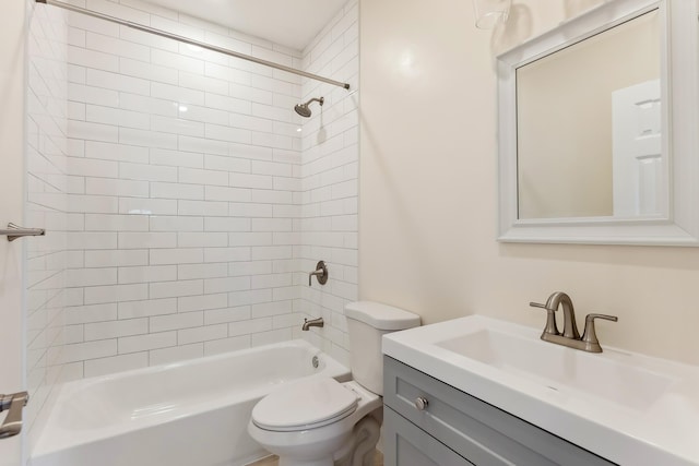 bathroom featuring toilet, shower / bathing tub combination, and vanity