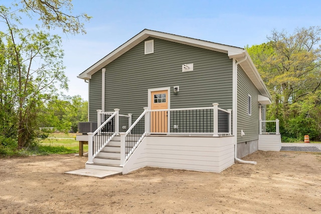 back of property with central AC