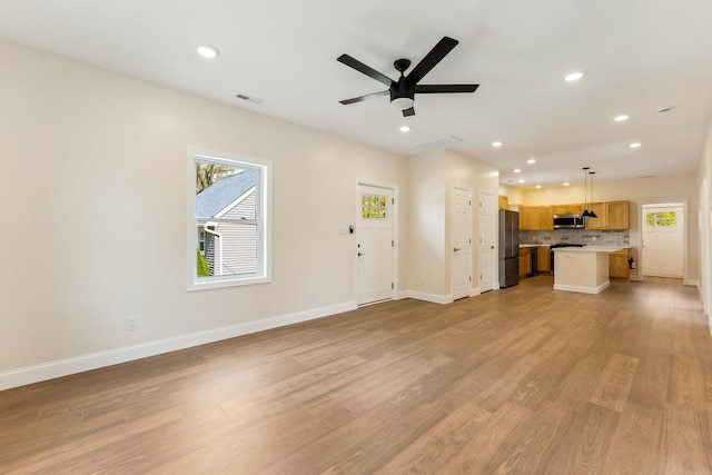 unfurnished living room with recessed lighting, visible vents, a healthy amount of sunlight, and light wood-type flooring