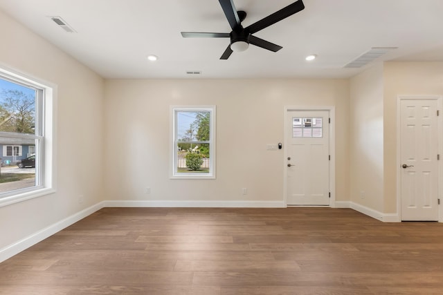 entryway featuring a ceiling fan, visible vents, and wood finished floors