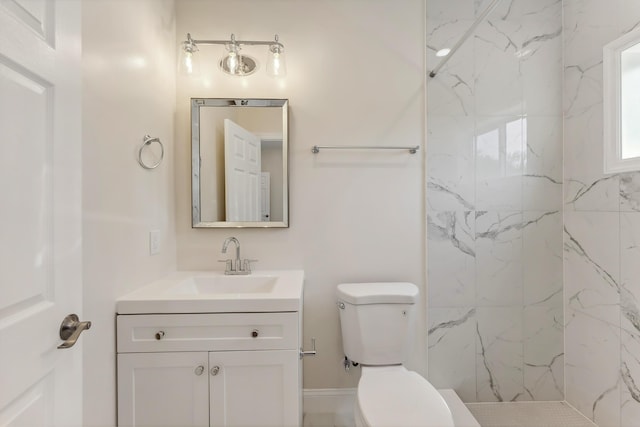 full bath featuring toilet, a marble finish shower, and vanity