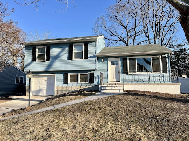 tri-level home featuring a garage and a porch