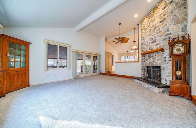 carpeted living room featuring a fireplace, high vaulted ceiling, ceiling fan, and beamed ceiling